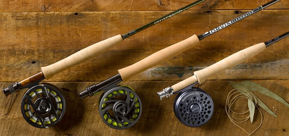 fly fishing rod and reel gear setup on riverbank