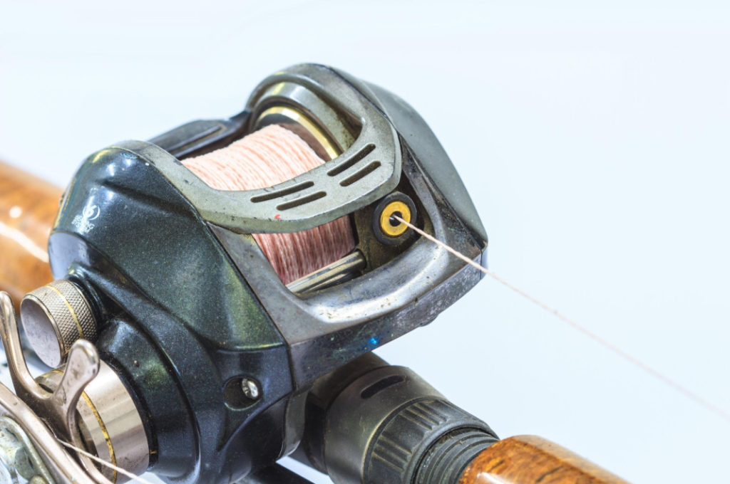 baitcasting reel mounted on fishing rod close up