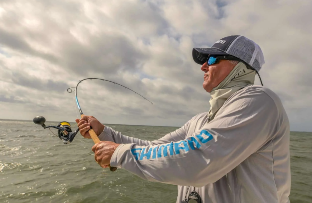 angler casting a fishing rod and reel in real fishing conditions