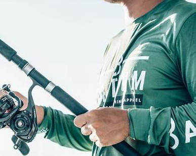 angler holding fishing rod and reel, ready to cast or retrieve