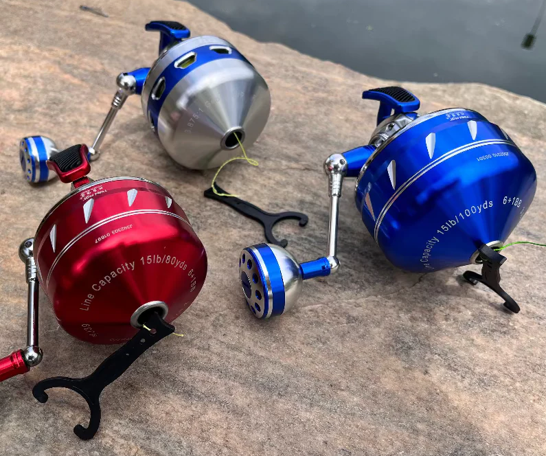 angler casting spincast reel from lake shore